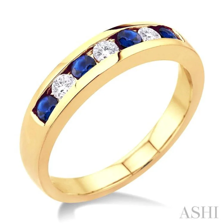 1/5 Ctw Channel Set Round Cut Diamond and 2.5 MM Round Cut Sapphire Band in 14K Yellow Gold